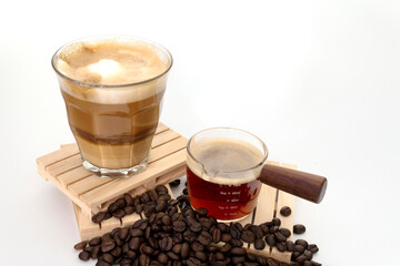 hot latte with coffee beans on white background