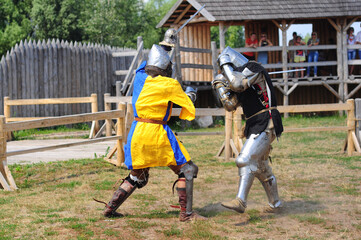 Kyiv, Ukraine. July 06, 2013. Two knights are fighting in armor with swords, reconstruction of the tournament
