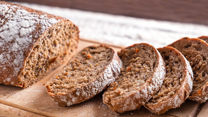 Sliced carrot bread on wooden board. Closeup