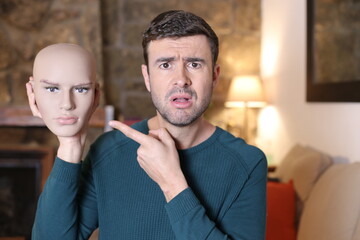 Man holding mannequin head with beautiful features 