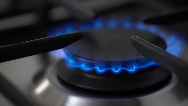 Gas stove burning and switching off. Blue flame from natural gas fire