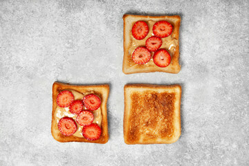 toasts with peanut butter and strawberries - 496886456