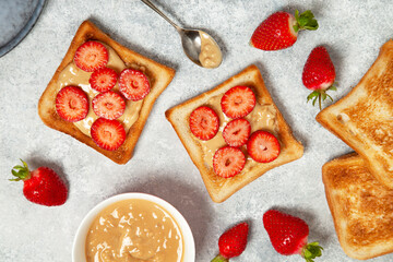 toasts with peanut butter and strawberries - 496886457
