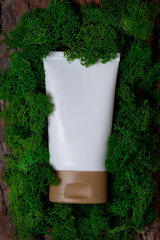 white empty tube on green moss - 496886460