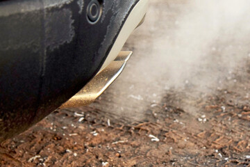 Smoke from the exhaust pipe of a modern car