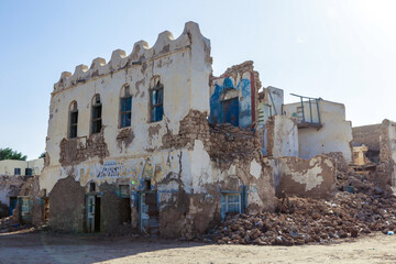 Berbera, Somaliland - November 10, 2019: Crushed Walls and Abandoned Buildings during War on the Streets of Berbera City - obrazy, fototapety, plakaty