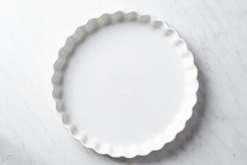 Fototapeta na wymiar Empty tart form on white backgound. White table with empty tart form