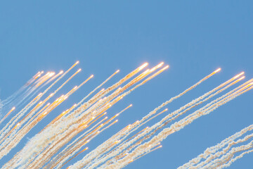 Outbreaks of warfare in the sky with explosives and smoke, fragments fly up.
