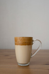 Dalgona coffee in a glass on a wooden table