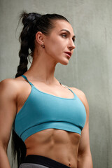 Fototapeta na wymiar Athletic young woman posing in the gym lifestyle portrait, caucasian model