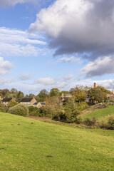 Fototapeta na wymiar An autumn sky over the Cotswold village of Brockhampton, Gloucestershire, England UK