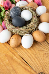 black colors painted easter eggs in decor nest. Happy Easter holiday card	
