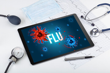 Tablet pc and doctor tools on white surface