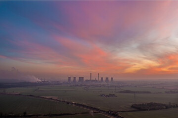 Fototapeta premium Landscape view of coal fired power station at sunset