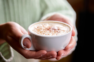 woman with cup of cappuccino