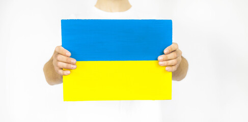 Guy with paper in the form of a yellow and blue flag of Ukraine on a white background.