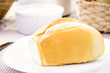 Fototapeta na wymiar Brazilian salt bread served for breakfast, called french bread, crispy and fresh from the oven