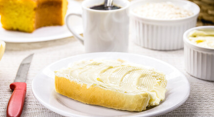 slice of salt bread cut with butter, called French bread in Brazil, Brazilian breakfast