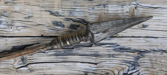 ancient spear on wooden background