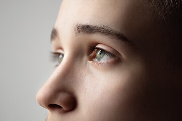 eye of a young man close-up, look up, natural eyebrows and eyelashes, vision check