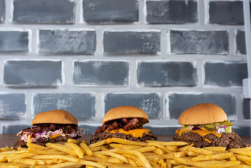 Smash burger trio on top of fries