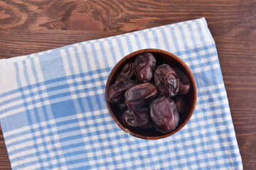 Ramadan dates meale served on wooden table covered with gingham