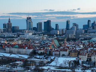 Widok na zamek królewki i stare miasto w Warszawie z drona, w tle wieżowce, zaśnieżone dachy, zachód słońca © Arkadiusz
