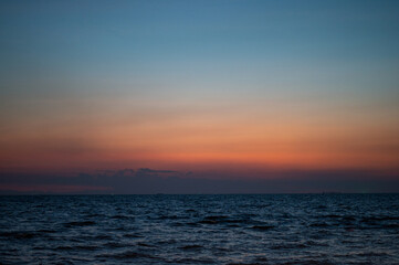 Beautiful sunset beach and light shining with waves breaking at Bang Saen Beach Chonburi province Thailand.