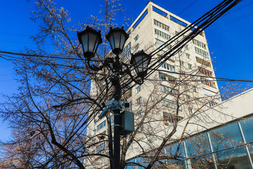 Lamppost on the background of the building and the sky.