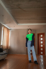 Fototapeta premium Beautiful young blonde girl posing in a home studio.