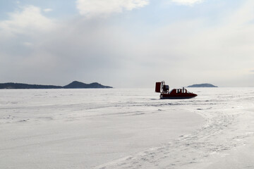 snowmobile on the ice of the frozen lake in sunny day