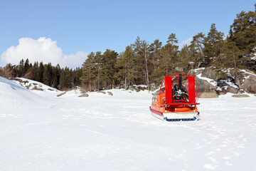 snowmobile on the ice of the frozen lake in sunny day