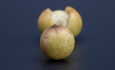 slice Baccaurea motleyana isolate on black background, selective focus