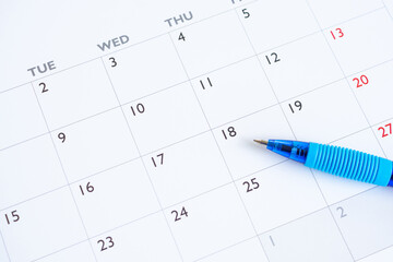 Blue pen on calendar page background business planning appointment meeting concept