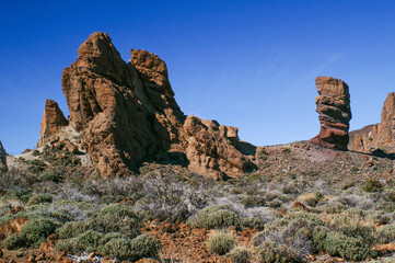 red brown rocks on tenerife against blue sky
