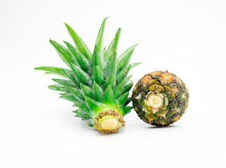 whole pineapple with slice leaves isolate on white,