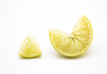 Lemon pieces close up isolated on white background