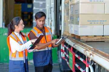 Warehouse workers discussing shipping schedule.