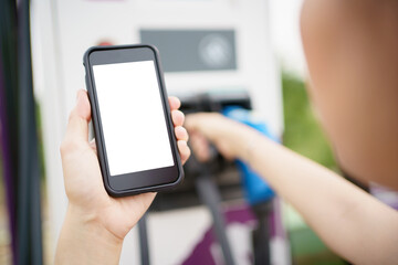 Empty screen of mockup smartphone isolated with clipping path. Asian young woman using ev charging application on smartphone.