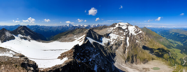 Panoramic view from Hoher Sonnblick on mountain ranges of High Tauern Alps in Carinthia, Salzburg, Austria, Europe. Goldberg group in Hohe Tauern National Park on a sunny day. View on Grossglockner