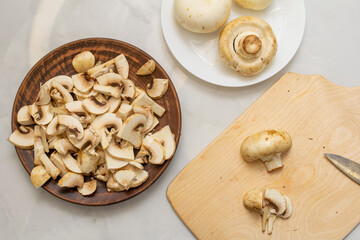 mushrooms in a bowl. cutting champignons. Fresh mushrooms. View from above
