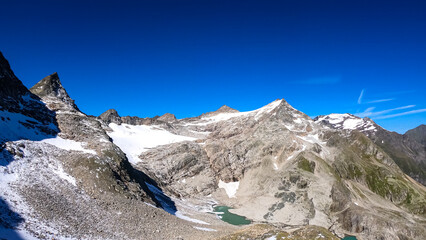 Panoramic view on Hoher Sonnblick in the High Tauern Alps in Carinthia and Salzburg, Austria, Europe. Glacier lakes of the Goldbergkees in the Hohe Tauern National Park. Patagonia like landscape. Snow