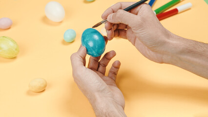 hand painting colorful easter eggs