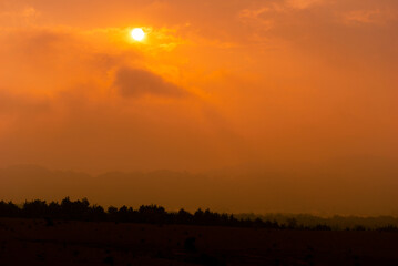 Sunset in Guatemala's routine area, cloudy sky and silhouettes on the horizon.