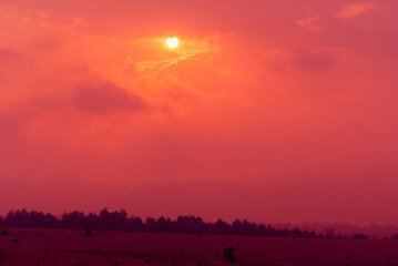 Sunset in Guatemala's routine area, cloudy sky and silhouettes on the horizon.