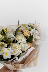 White delicate bouquet. Alstroemeria, roses, tulips, iris in a bouquet