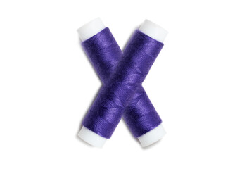 Letter of X from thread spools, isolated on white background. Alphabet concept.