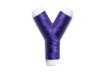 Letter of Y from thread spools, isolated on white background. Alphabet concept.