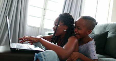 Mother multi-tasking working from hom with child, parent trying to focus