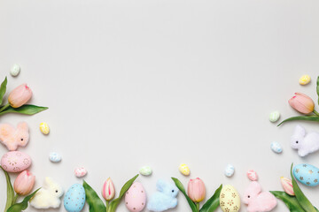Naklejka na ściany i meble Easter composition. Tulips eggs toy rabbits on a gray background.